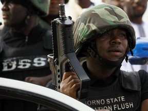 In this file photo taken on Thursday, Aug. 8, 2013, Nigerian security forces stand guards during Eid al-Fitr celebration in Maiduguri, Nigeria.