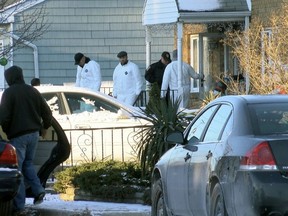 Authorities investigate outside a home in Long Branch, N.J., Monday, Jan. 1, 2018. A 16-year-old has been arrested after his parents, sister and a family friend were found dead inside the home where they lived, authorities said Monday.