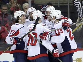 Washington Capitals celebrate a goal by Brett Connolly (10) during the first period of an NHL hockey game against the New Jersey Devils, Thursday, Jan. 18, 2018, in Newark, N.J.