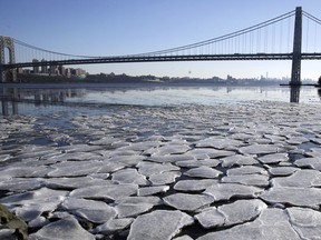 A layer of ice is broken into pieces floating along the banks of the Hudson River at the Palisades Interstate Park with the George Washington Bridge in the background, Tuesday, Jan. 2, 2018, in Fort Lee, N.J. The Northern New Jersey region continued to experienced deep cold weather to start the new year.