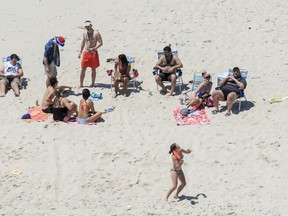 FILE - In this July 2, 2017, file photo, New Jersey Gov. Chris Christie, right, uses the beach with his family and friends at the governor's summer house at Island Beach State Park, N.J., when the state park was closed to the public during a government shutdown in New Jersey. Christie leaves office Tuesday, Jan. 16, 2018, but don't expect the colorful, candid, at-times crude and historically unpopular two-term Republican governor to leave the public eye any time soon.