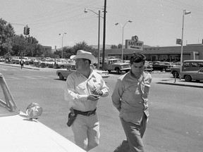 FILE - In this June 1967 file photo, Reies Lopez Tijerina, right, is led into court by Arthur F. Garcia Santa Fe county under-sheriff in Santa Fe, N.M. The 1968 murder of a New Mexico Hispanic jailer, Eulogio Salazar who was preparing to testify against Hispanic land grant leader-activist Tijerina and his followers remains a mystery. The group was accused of leading an armed raid of the Tierra Amarilla Courthouse several months earlier. Tijerina long denied any role in Salazar's murder.