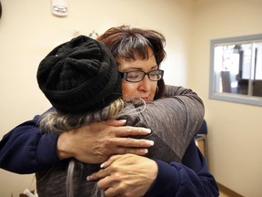 In this Thursday, Dec. 21, 2017 photo Joleen Valencia, who was held past her scheduled parole date while serving a drug-trafficking sentence, embraces social worker Sheila Ciminera at The Pavilions, a residential re-entry program in Los Lunas, N.M. New Mexico prison records show the state has held hundreds of inmates, like Valencia, past their projected parole dates under a practice widely known as "in-house parole."