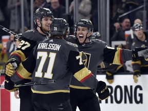 Vegas Golden Knights' Shea Theodore (27), William Karlsson (71) and Jonathan Marchessault celebrate Karlsson's goal against the Edmonton Oilers during the second period of an NHL hockey game Saturday, Jan. 13, 2018, in Las Vegas.