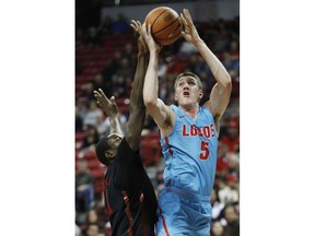 New Mexico's Joe Furstinger shoots over UNLV's Cheickna Dembele during the first half of an NCAA college basketball game Wednesday, Jan. 17, 2018, in Las Vegas.