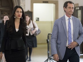 FILE - In this Sept. 13, 2017 file photo, former congressman Anthony Weiner, right, and his estranged wife, Huma Abedin, left, leave court in New York.  The couple was supposed to appear before a Manhattan judge Wednesday, Jan. 10, 2018,  but the judge said both sides had agreed to discontinue the case. Abedin filed a divorce from Weiner in May and listed it as "contested," which meant they had to negotiate in front of a judge. But now the parties can re-file as "uncontested" and won't have to make their discussion public.