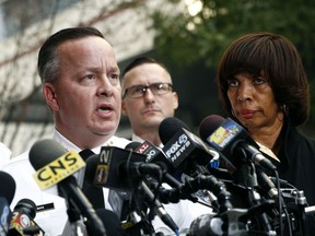 FILE - In this Nov. 16, 2017 file photo, Baltimore Police Department Commissioner Kevin Davis, left, speaks alongside Mayor Catherine Pugh at a news conference outside the R Adams Cowley Shock Trauma Center in Baltimore. Pugh has replaced the city's police commissioner, saying a change in leadership is needed to reduce crime.  A news release from the mayor's office Friday, Jan. 19, 2018,  says Deputy Commissioner Darryl DeSousa will take Kevin Davis' place. The release says DeSousa, a 30-year veteran of the force, will assume responsibility immediately.