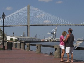FILE - This Sept. 28, 2017 file photo shows the Eugene Talmadge Memorial Bridge over the Savannah river, in Savannah, Ga.  The Girl Scouts have hired a lobbyist, met with the governor and made plans for a milk-and-cookies reception for Georgia lawmakers as they try to get a Savannah bridge renamed for Girl Scouts founder Juliette Gordon Low.  Sue Else of the Girls Scouts of Historic Georgia says up to 300 scouts will visit the state Capitol in February 2018 to meet with lawmakers about the bridge.