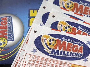 FILE - In this July 1, 2016, file photo, Mega Millions lottery tickets rest on a counter at a Pilot travel center near Burlington, N.C.  The jackpot for the Mega Millions lottery game has climbed to over $450 million, just hours before the drawing, Friday, Jan. 5, 2018.