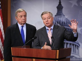 FILE - In this Tuesday, Sept. 5, 2017, file photo, Sen. Lindsey Graham, R-S.C., right, with Sen. Dick Durbin, D-Ill., speak during a news conference on Capitol Hill in Washington, to discuss their bipartisan Dream Act. A 12-year pathway to citizenship for young immigrants brought to the U.S. as children and who are here illegally is part of a bipartisan immigration proposal by senators to prevent deportation of hundreds of thousands of so-called Dreamers. The Associated Press on Saturday, Jan. 13, 2018 obtained details of the agreement between three Republican and three Democratic senators. The deal also calls for allocating $1.6 billion for structures including a wall for border security.