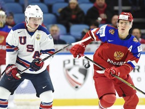 FILE - In this Tuesday, Jan. 2, 2018 file photo, United States forward Casey Mittelstadt (11) and Russia forward Mikhail Maltsev (13) vie for the puck during the first period of a quarterfinal in the IIHF world junior hockey championships in Buffalo, N.Y. A funny thing happened when the offensively challenged Sabres left town for two weeks to make way for the world junior hockey championship. Buffalo's win-starved hockey fans got a glimpse of a far more promising future in the likes of Casey Mittelstadt.