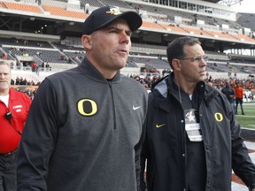 FILE - In this Nov. 26, 2016, file photo, then-Oregon head coach Mark Helfrich, center, comes onto the field for an interview before an NCAA college football game against Oregon State, in Corvallis, Ore. The Chicago Bears have hired former Oregon coach Mark Helfrich as their offensive co-ordinator. The Bears also announced Friday, Jan. 12, 2018, that Chris Tabor will become special teams co-ordinator and Charles London will take over as running backs coach.