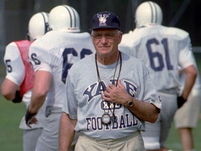FILE - In this Aug. 27, 1996, file photo, Yale University head football coach Carmen Cozza walks across the practice field in West Haven, Conn. Cozza, who led Yale to a share of 10 Ivy League titles during 32 years as coach died Thursday, Jan. 4, 2018, the university said. He was 87.