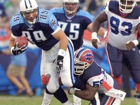 FILE- In this Aug. 16, 2003, file photo, Tennessee Titans wide receiver Frank Wycheck (89) is brought down by Buffalo Bills linebacker London Fletcher (59) on the first play from scrimmage in the first quarter of their preseason game in Nashville, Tenn. Wycheck says he's glad the Bills have finally returned to the playoffs, 18 years after he threw the key lateral during a kickoff return that gave the Titans a playoff win over Buffalo in a play dubbed the "Music City Miracle."