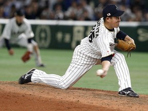 FILE - In this March 15, 2017, file photo, Japan's closer Kazuhisa Makita pitches against Israel during the ninth inning of their second round game of the World Baseball Classic at Tokyo Dome in Tokyo. Makita is guaranteed $3.8 million in his two-year contract with the San Diego Padres. Makita has salaries of $1.9 million in each of the next two seasons under the deal announced Saturday.