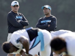 FILE - In this Aug. 3, 2015, file photo, Carolina Panthers head coach Ron Rivera, left, talks with assistant head coach Steve Wilks, right, as players warm up during the NFL football team's training camp in Spartanburg, S.C. The New York Giants have Wilks for their vacant head coaching job on Tuesday, Jan. 9, 2018.