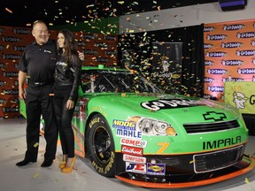 FILE - In this Aug. 25, 2011, file photo, Go Daddy.com founder Bob Parsons, left, sponsor for NASCAR driver Danica Patrick, right, unveil Patrick's car she will drive full-time in the NASCAR Nationwide Series circuit and select Sprint Cup races during an auto racing news conference, in Scottsdale, Ariz. Patrick is teaming with Premium Motorsports for next month's Daytona 500, the final race of her NASCAR career. The one-race deal will put Patrick in the seat of the No. 7 GoDaddy Chevrolet, the same car number she drove when she entered stock-car racing in 2010.