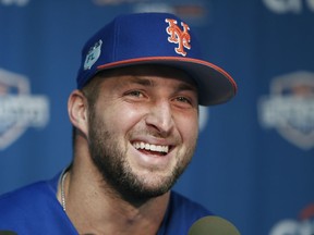 FILE - In this Feb. 27 2017, file photo, New York Mets outfielder and former NFL quarterback Tim Tebow laughs during a news conference at the baseball teams spring training facility in Port St. Lucie, Fla. Tebow will attend major league spring training with the New York Mets. The 30-year-old outfielder was among nine spring training invitees announced by the team Friday, Jan. 19, 2017.