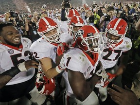 FILE - In this Monday, Jan. 1, 2018, file photo ,Georgia tailback Sony Michel (1) celebrates with teammates after scoring the game-winning touchdown in the second overtime period to give Georgia a 54-48 win over Oklahoma in the Rose Bowl NCAA college football game in Pasadena, Calif. Georgia coach Kirby Smart is concerned the emotional drain from the Rose Bowl playoff semifinal win over Oklahoma could affect his team's ability to regroup for the national championship game against Alabama.