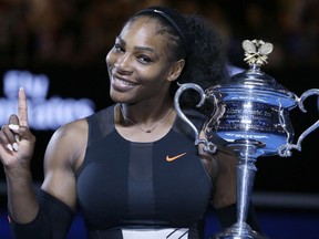 FILE - In this Jan. 28, 2017, file photo, Serena Williams holds up a finger and her trophy after defeating her sister, Venus, in the women's singles final at the Australian Open tennis championships in Melbourne, Australia. Serena Williams tells Vogue that she dealt with a medical scare right after the birth of her daughter. In a story in the magazine's February issue and posted Wednesday, Jan. 10, 2018, on Vogue.com , Williams discusses developing several small blood clots in her lungs while in the hospital after Alexis Olympia Ohanian Jr. was born in September.