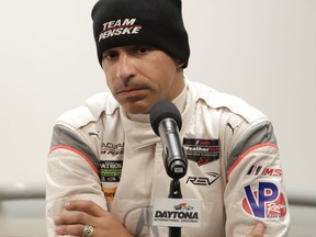 FILE - In this Friday, Jan. 5, 2018, file photo, Penske team driver Helio Castroneves, of Brazil, makes comments at a news conference during testing for the IMSA 24 hour auto race at Daytona International Speedway in Daytona Beach, Fla. Castroneves is one of the most popular, beloved and accomplished drivers in IndyCar Series history. So go check him out in sports cars, where the Brazilian is about to find out if an old driver can learn new tricks.  Castroneves is the anchor of Roger Penske's new sports car team, which will make its official debut this weekend at the Rolex 24 Hours of Daytona.