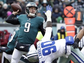 FILE - In this Dec. 31, 2017, file photo, Philadelphia Eagles' Nick Foles (9) throws a pass over Dallas Cowboys' DeMarcus Lawrence (90) during the first half of an NFL football game in Philadelphia. The Eagles earned the top seed in the NFC playoffs for the first time since 2004.