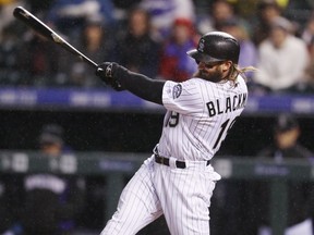 FILE - In this April 21, 2017, file photo, Colorado Rockies' Charlie Blackmon follows through with his swing after connecting for a two-run inside-the-park home run off San Francisco Giants starting pitcher Johnny Cueto in the fourth inning of a baseball game, in Denver. NL batting champion Charlie Blackmon and the Colorado Rockies avoided salary arbitration by agreeing to a $14 million, one-year contract, Friday, Jan. 12, 2018.