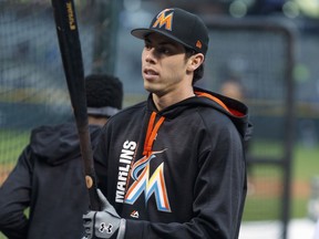 FILE - In this Sept. 25, 2017, file photo, Miami Marlins center fielder Christian Yelich steps out of the cage during batting practice before the team's baseball game against the Colorado Rockies in Denver. The Marlins sent Yelich to the Milwaukee Brewers for four prospects on Thursday, Jan. 25, 2018.