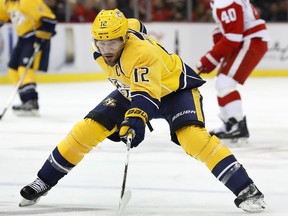 FILE - In this Oct. 21, 2016, file photo, Nashville Predators center Mike Fisher (12) reaches for the puck against Detroit Red Wings in the first period of an NHL hockey game in Detroit. Predators general manager David Poile announced Wednesday, Jan. 31, 2018, that Fisher is coming out of retirement to make a comeback and play once more. The team hopes to sign a contract around the Feb. 26 trade deadline.