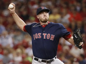 FILE - In this Sept. 22, 2017, file photo, Boston Red Sox relief pitcher Addison Reed throws in the eighth inning of a baseball game against the Cincinnati Reds in Cincinnati. The right-handed reliever and the Minnesota Twins finalized a $16.75 million, two-year contract over the weekend, putting another pitcher with closing experience in the back of the Twins' bullpen.