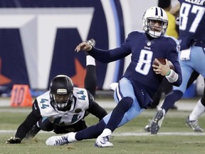 FILE - In this Sunday, Dec. 31, 2017, file photo, Tennessee Titans quarterback Marcus Mariota (8) is brought down by Jacksonville Jaguars outside linebacker Myles Jack (44) in the second half of an NFL football game in Nashville, Tenn. The Jaguars, Bills and Titans all ended long droughts to return to the playoff party.