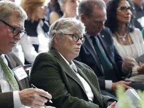 In this Oct. 20, 2017, photo, Michigan State University President Lou Anna Simon listens during the dedication ceremony for the Gilbert Pavilion and Tom Izzo Hall of History inside Michigan State's Breslin Student Events Center in East Lansing, Mich. At left is Brian Breslin, of the university's Board of Trustees. Simon submitted her resignation Wednesday amid an outcry over the school's handling of allegations against Larry Nassar.