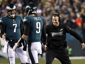 FILE - In this Sunday, Jan. 21, 2018, file photo, Philadelphia Eagles' Carson Wentz, right,  congratulates Nick Foles (9) during the second half of the NFL football NFC championship game against the Minnesota Vikings in Philadelphia. Wentz, who is injured, watched both playoff games from the sideline, rooting hard for his teammates and enjoying their success without him. He'll be their No. 1 fan Sunday when they take on the New England Patriots and try to win the franchise's first NFL title since 1960.