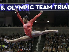 FILE - In this July 10, 2016, file photo, Simone Biles competes on the balance beam during the women's U.S. Olympic gymnastics trials in San Jose, Calif. Biles has met the new president of USA Gymnastics but hasn't heard from the U.S. Olympic Committee regarding the Larry Nassar sexual abuse scandal. The four-time gold medalist at the Rio Games is training for the 2020 Tokyo Olympics.