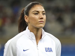 FILE - In this Aug. 3, 2016, file photo, United States goalkeeper Hope Solo stands as players listen to the national anthems before a women's Olympic football tournament match against New Zealand at the Mineirao stadium in Belo Horizonte, Brazil. The former U.S. women's national team goalkeeper, among eight candidates running in the Feb. 10 election to succeed Sunil Gulati as USSF president, has filed a complaint against the U.S. Soccer Federation with the U.S. Olympic Committee, accusing it of illegally favoring Major League Soccer.