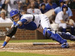 FILE - In this Monday, Aug. 14, 2017 file photo, Chicago Cubs catcher Alex Avila snags a wide throw from second baseman Tommy La Stella during the eighth inning of a baseball game against the Cincinnati Reds in Chicago. The Arizona Diamondbacks have finalized an $8.25 million, two-year contract with free agent catcher Alex Avila, Wednesday, Jan. 31, 2018.