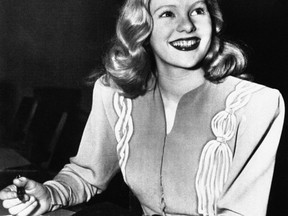 FILE - In this Dec. 26, 1945, file photo, actress Peggy Cummins, 20, smiles in Superior Court, in Los Angeles, after her contract with Twentieth Century-Fox Studio had been approved. Cummins, who gave an indelible performance as the lethal, beret-wearing robber in the noir classic "Gun Crazy," has died. Cummins, who retired from acting in the early 1960s, died Friday, Dec. 29, 2017, in London at age 92.  (AP Photo/File)