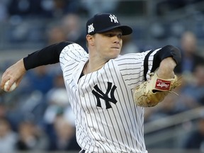 FILE - In this Oct. 17, 1017, file photo, New York Yankees starting pitcher Sonny Gray throws during the first inning of Game 4 of baseball's American League Championship Series against the Houston Astros in New York. The Yankees have reached one-year contracts with their remaining six players eligible for arbitration, leaving their projected luxury tax payroll at $177 million. Gray agreed at $6.5 million Friday, Jan. 12, 2018.