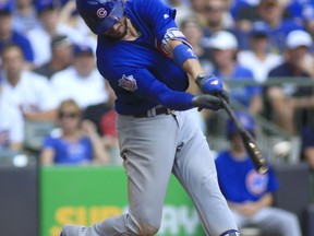 FILE - In this Sept. 24, 2017, file photo, Chicago Cubs third baseman Kris Bryant hits an RBI-double against the Milwaukee Brewers during the fourth inning of an baseball game in Milwaukee. The hot corner figures to be smoking Friday, Jan. 12, 2018, when players and team swap proposed salaries in arbitration. Toronto's Josh Donaldson, Baltimore's Manny Machado, Washington's Anthony Rendon and Bryant were among the more than 170 players headed to the exchange.