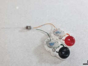 This undated image provided by researcher Canan Dagdeviren in January 2018 shows an implant that can precisely drip medications deep into the brain by remote control. The device could mark a new approach to treating brain diseases _ potentially reducing side effects by targeting only the hard-to-reach specific sections that need care.