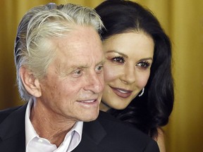 FILE - In this Dec. 9. 2016, file photo, actor Michael Douglas and his wife, actress Catherine Zeta-Jones, attend a party at the Beverly Hills Hotel in Beverly Hills, Calif. Catherine Zeta-Jones said that her husband, who has denied allegations of sexual harassment, is a strong supporter of the #MeToo movement.