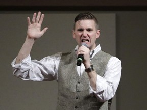 FILE - In this Dec. 6, 2016, file photo, Richard Spencer speaks at the Texas A&M University campus in College Station, Texas. Spencer's campus tour organizer is suing the University of Cincinnati's president, saying the school wouldn't rent space for Spencer to speak on campus unless a nearly $11,000 security fee was paid. An attorney for Spencer and the organizer says requiring such payment because a speaker is controversial or prompts hostile reaction is discriminatory and unconstitutional.