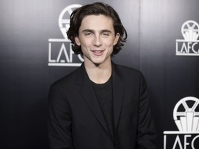 FILE - In this Jan. 13, 2018, file photo, Timothee Chalamet attends the 43rd Annual Los Angeles Film Critics Association Awards in Los Angeles. Chalamet said he will donate his salary for an upcoming Woody Allen film to charities fighting sexual harassment and abuse.