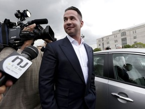 FILE - In this Sept. 24, 2014, file photo, reporters gather around Mike "The Situation" Sorrentino as he leaves the MLK Jr. Federal Courthouse in Newark, N.J., after a court appearance. Former "Jersey Shore" reality TV star Sorrentino is expected to plead guilty to federal tax charges. A letter filed with the court on Wednesday, Jan. 17, 2018, said Sorrentino and his brother, Marc, plan to plead guilty at a court hearing on Friday in Newark. The pair was charged in 2014 with filing bogus tax returns on nearly $9 million in income. Additional charges were filed last April.