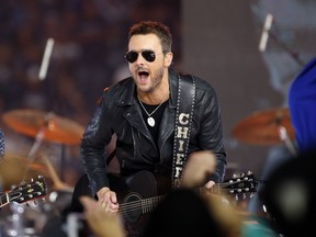 FILE - In this Nov. 24, 2016, file photo, Country music singer Eric Church performs at halftime during an NFL football game between the Washington Redskins and Dallas Cowboys in Arlington, Texas. Church, Maren Morris and Brothers Osborne, who all performed at the three-day festival prior to the mass shooting October 2017, will collaborate on a special performance at the 60th annual Grammy Awards, airing live on CBS from New York City on Jan. 28, 2018.