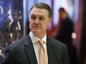 FILE - In this Dec. 2, 2016, file photo, Sen. David Perdue, R-Ga., walks to the elevator for a meeting with President-elect Donald Trump at Trump Tower, in New York. Casting a cloud over already tenuous negotiations, President Donald Trump said Sunday, Jan. 14, 2018, that Deferred Action for Childhood Arrivals program, or DACA, a program that protects immigrants who were brought to the U.S. as children and live here illegally is "probably dead" and blamed Democrats, days before some government functions would start shutting down unless a deal is reached. Perdue said "the potential is there" for a deal to protect the "Dreamers" but that Democrats needed to get serious.