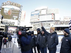 Troy Terry waves to the crowd as the roster for the men's USA Olympic hockey team is announced at the NHL Winter Classic hockey game between the Buffalo Sabres and the New York Rangers at CitiField in New York on Monday, Jan. 1, 2018.