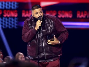 FILE - In this Sunday, Nov. 19, 2017, file photo, DJ Khaled accepts the award for favorite song rap/hip-hop for "I'm the One" at the American Music Awards at the Microsoft Theater in Los Angeles. Weight Watchers International climbed after it struck a deal with producer and recording artist DJ Khaled, who will represent the brand to millions of follows on Snapchat, Twitter, Instagram and Facebook.