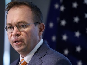 FILE - In this Monday, Nov. 27, 2017, file photo, Mick Mulvaney speaks during a news conference after his first day as acting director of the Consumer Financial Protection Bureau in Washington. The CFPB is reconsidering a key set of rules enacted in 2017 that would have protected consumers against harmful payday lenders. The bureau, now under Trump administration control, says it plans to take a second look at rules put in place last year under an Obama appointee.