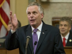 FILE - In this Jan. 10, 2018 file photo, Virginia Gov. Terry McAuliffe gestures as he addresses a joint session of the the 2018 session in the House chambers at the Capitol in Richmond, Va. McAuliffe told a national television audience he'd knock President Donald Trump to the floor if the president ever tried to intimidate him. During an interview Thursday, Jan. 11 on MSNBC's "Hardball," Chris Matthews asked McAuliffe how he would respond if Trump tried to intimidate him during a debate by hovering over him, as he did in a 2016 debate with Hillary Clinton, a close friend of McAuliffe's.